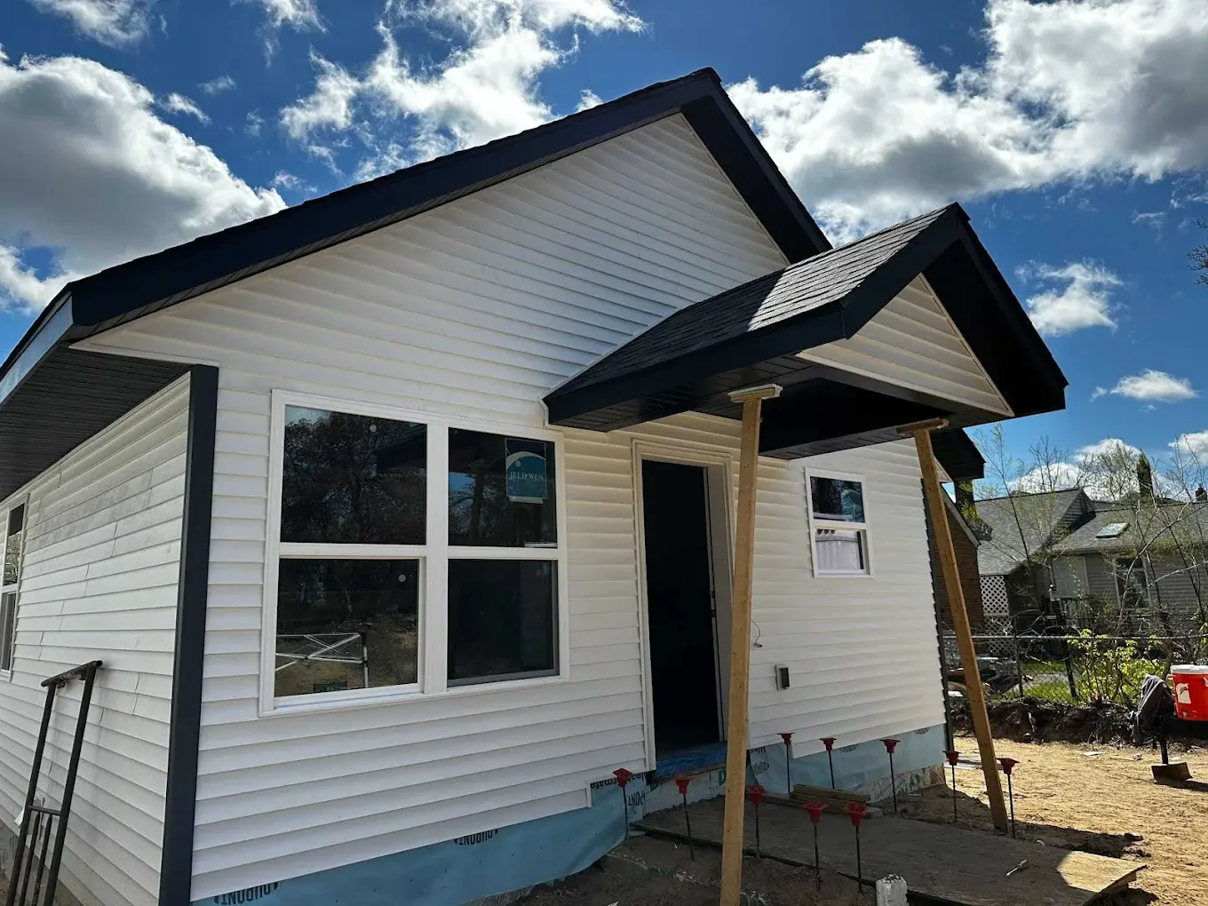 Near-complete detached accessory dwelling unit with white siding on a Seattle lot