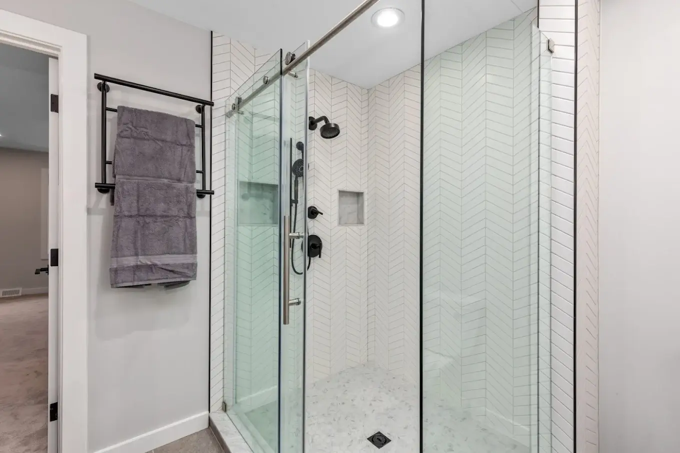 Finished bathroom with patterned accent tile and custom tile surround
