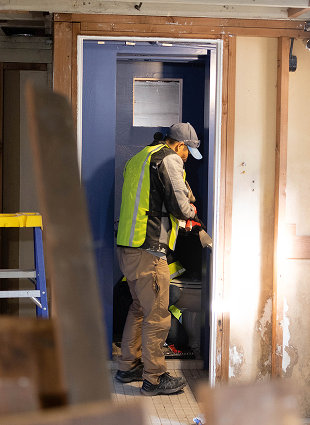 Worker stepping through a newly framed doorway